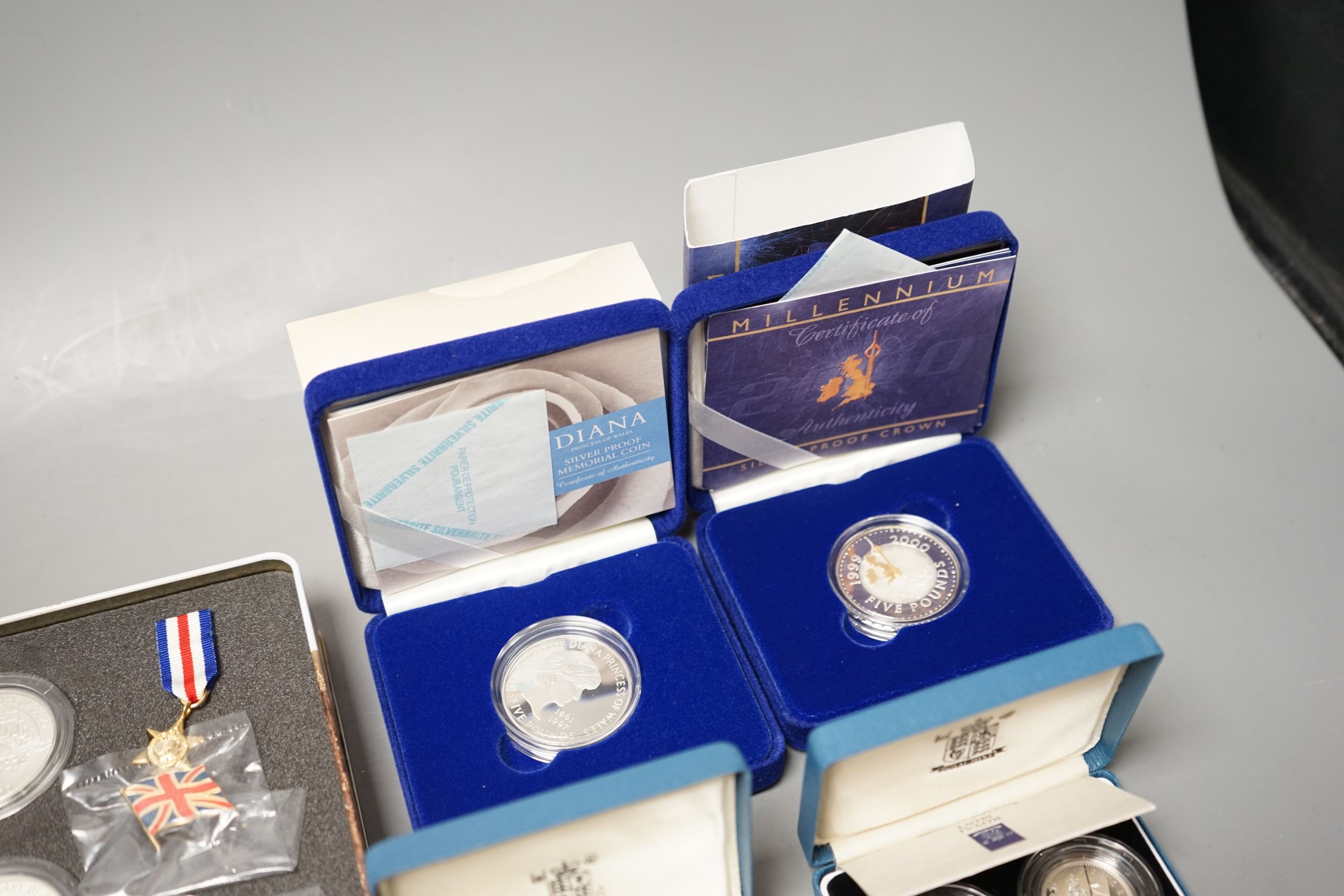 Cased Royal Mint UK proof coins – a Diana Memorial silver coin, a Millennium £5, a D-day 3 coin silver medal set, a 1992 two coin 10p set and a 1989 two coin £2 set